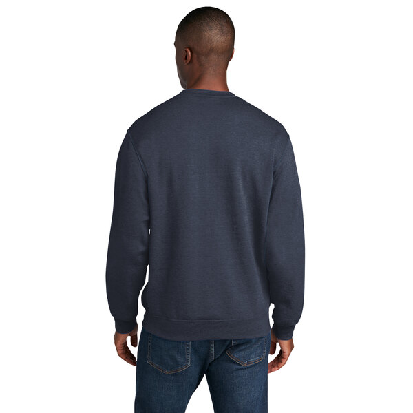 A man wearing a Port & Company heather navy core fleece crewneck sweatshirt.
