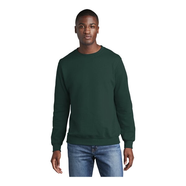 A man wearing a Port & Company dark green core fleece sweatshirt.