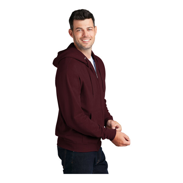 A man wearing a Port & Company maroon full-zip hoodie.