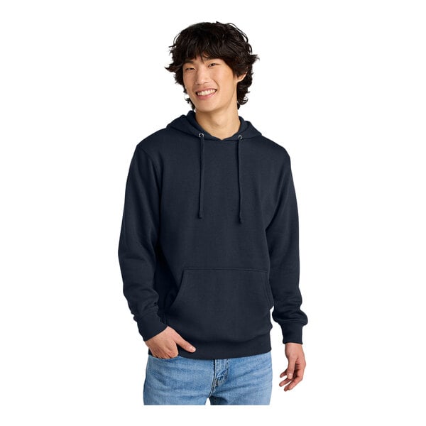 A man wearing a dark blue District sweatshirt with a hood.