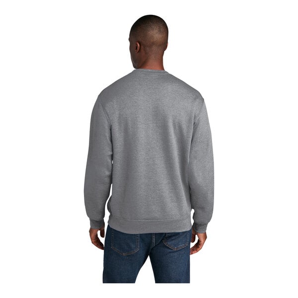 A man wearing a Port & Company athletic heather grey sweatshirt.