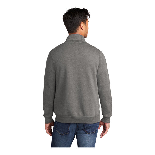 A man wearing a Port & Company graphite heather quarter-zip sweatshirt.