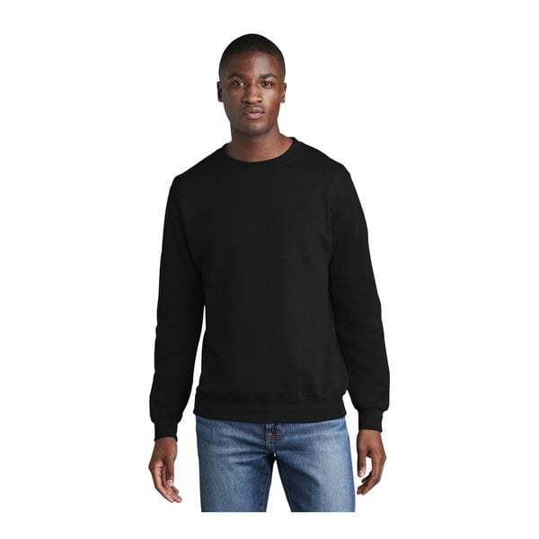 A man wearing a black Port & Company crewneck sweatshirt.