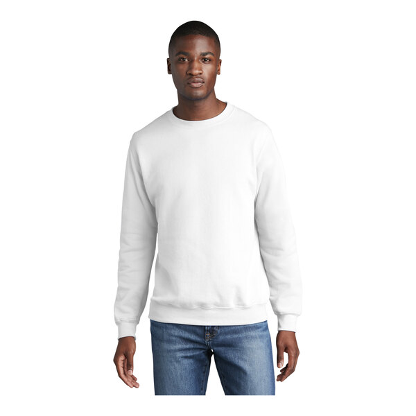 A man wearing a white Port & Company crewneck sweatshirt.