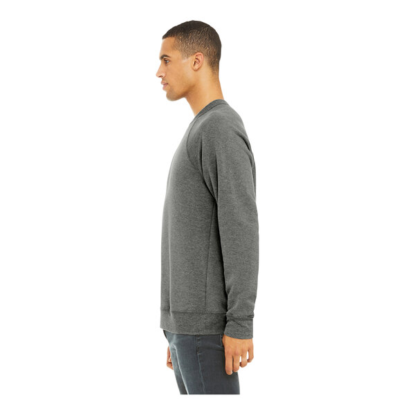 A man wearing a Bella + Canvas grey triblend sweatshirt with grey sleeves.