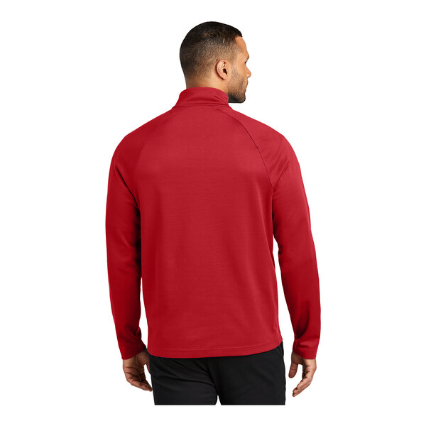 A man wearing a Port Authority red quarter-zip sweatshirt.