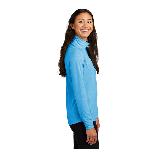 A woman wearing a blue Sport-Tek quarter-zip pullover.