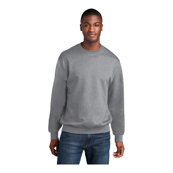 A man wearing a Port & Company athletic heather fleece crewneck sweatshirt.