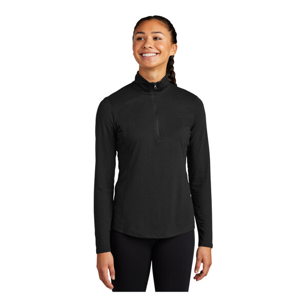 A woman wearing a black Sport-Tek Triad quarter-zip pullover.