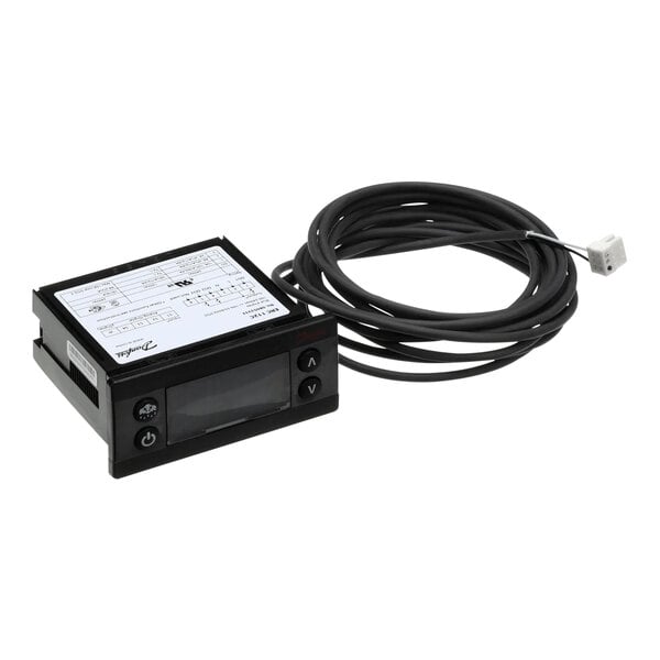 A black electronic temperature controller with a white label and a cable.