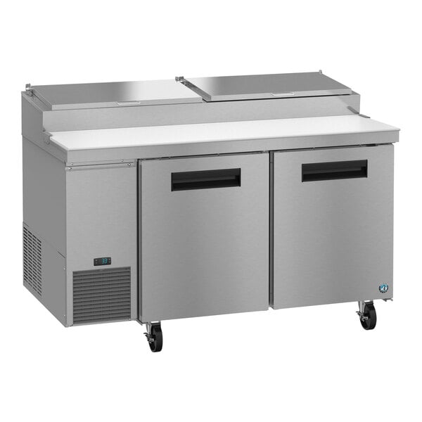 A silver stainless steel Hoshizaki pizza prep table with two doors.