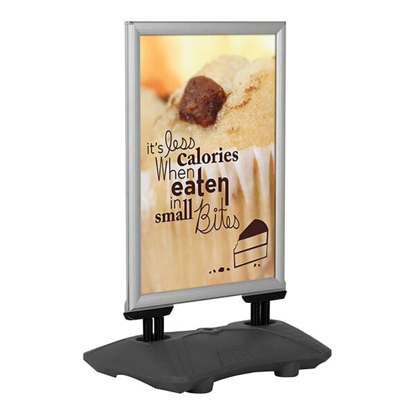 An MT Displays silver A-frame sign board with a cupcake on it.