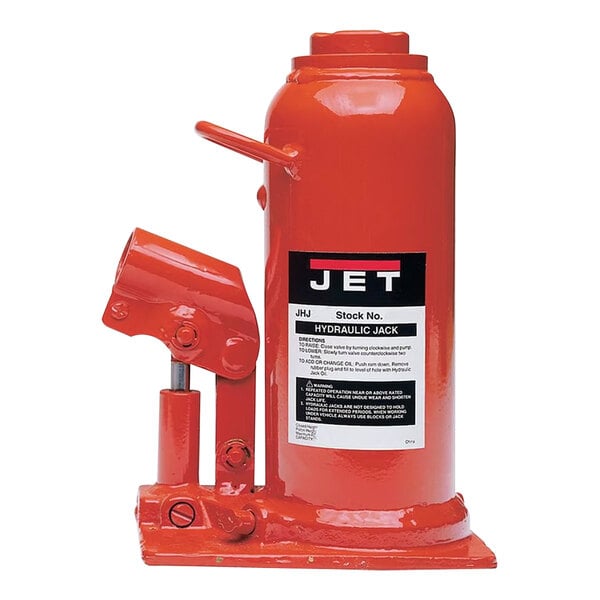 A red metal JET hydraulic bottle jack with a handle.