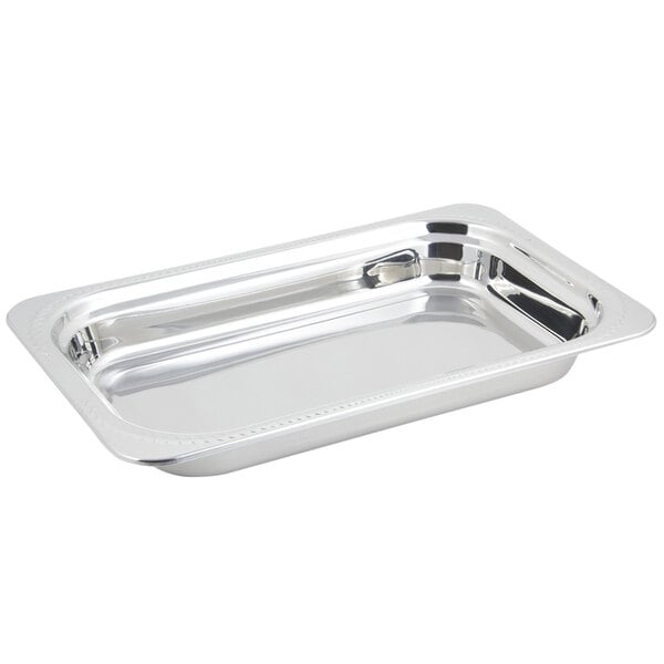 A stainless steel Bon Chef rectangular food pan with a laurel design.