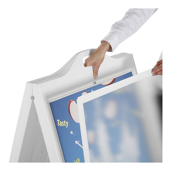 A person using a white MT Displays Street SignPro A-Frame sign board with plastic covers to display a picture.
