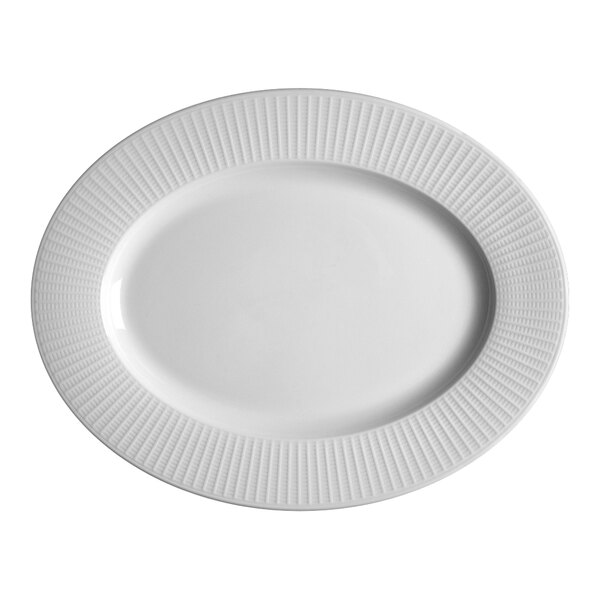 A close-up of a Steelite white oval plate with a wavy pattern.