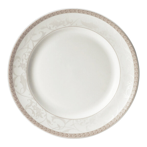 A close up of a Steelite Antoinette white plate with a gold border and floral design.