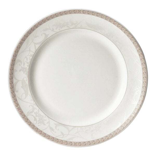 A close up of a Steelite Antoinette white plate with a gold border and floral design.