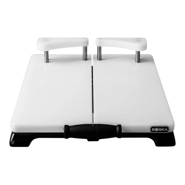 A white rectangular cheese slicer with black handles.