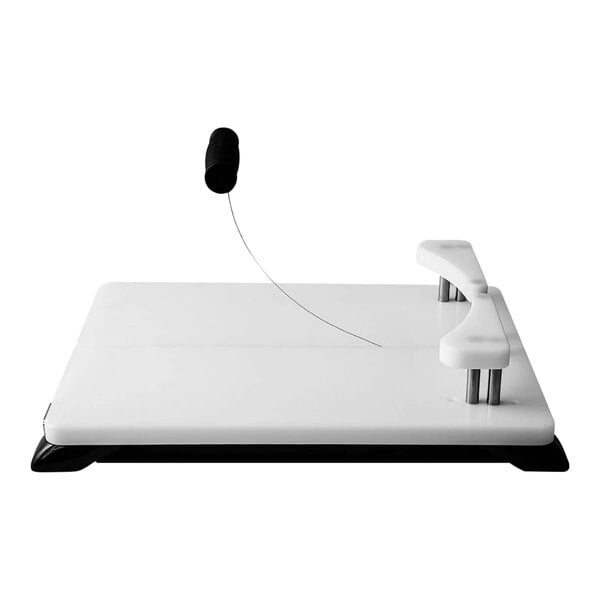 A black Boska Cheese-O-Matic electronic cheese cutter on a white table.