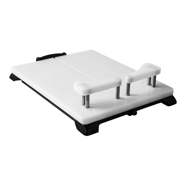 A white plastic Boska Cheese-O-Matic with metal rods and a black rectangular object.