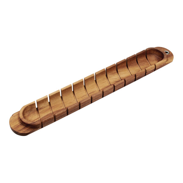 An Ironwood acacia wood baguette miter on a table with rows of wooden compartments.