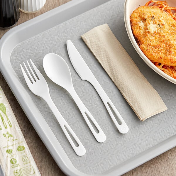 A tray with a wrapped fork, knife, and spoon on it.