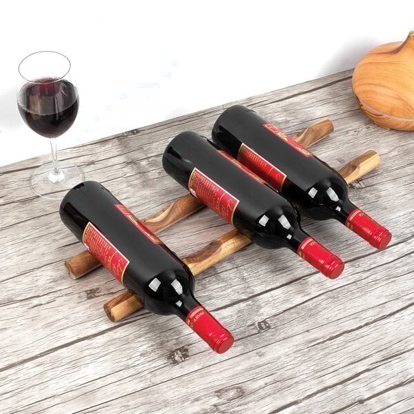 Two Ironwood acacia wood wine sticks holding three wine bottles.