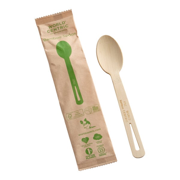 A compostable bamboo spoon and its individual paper wrapper.