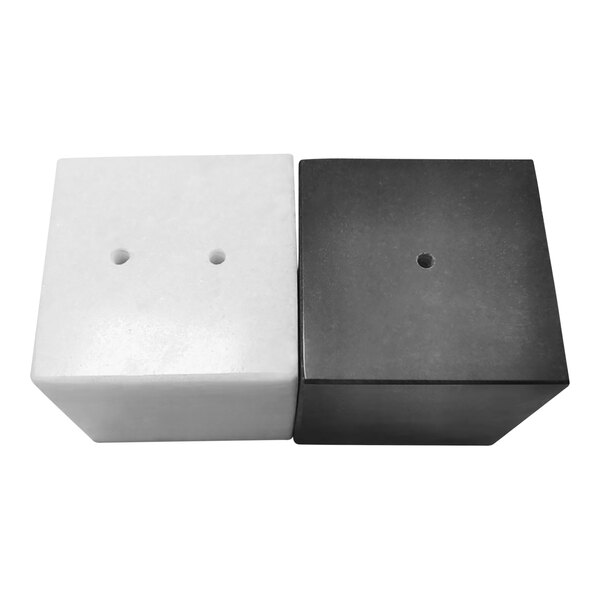 A black and white marble salt and pepper shaker set with square cubes and holes.