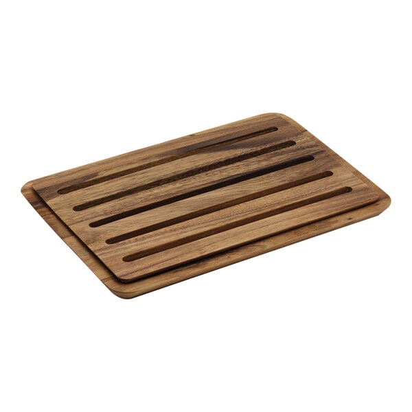 An Ironwood acacia wood bread cutting board on a table.