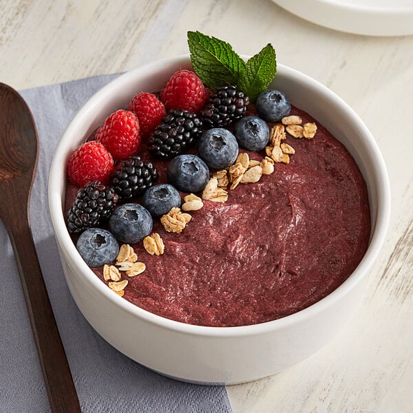 A bowl of Acai Glee smoothie with berries.