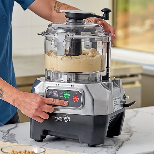 A commercial food processor with a clear batch bowl and digital controls, labeled as AvaMix Goliath.
