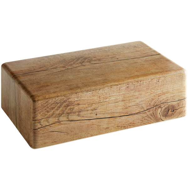 A rectangular wooden block with cracks on a white background.