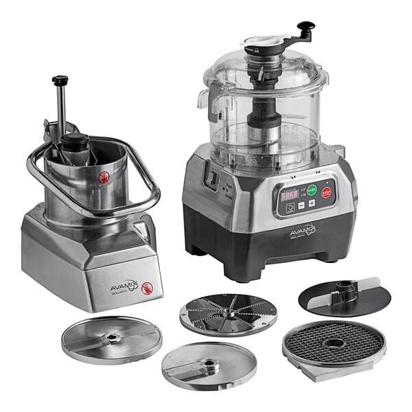 A commercial food processor set with a clear plastic bowl, continuous feed attachment, and multiple stainless steel discs.