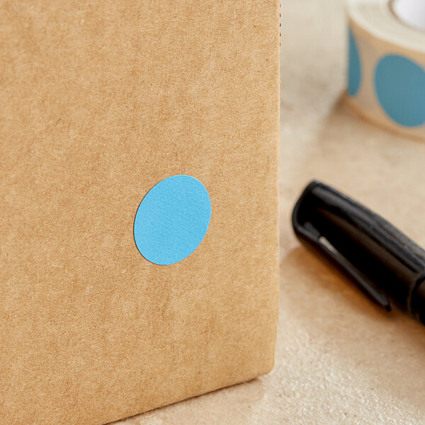 A brown box with a Lavex sky blue round sticker on it.