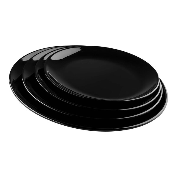 A stack of Tablecraft Sierra Collection black melamine serving platters.