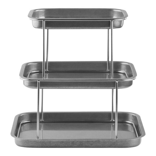 A Tablecraft 3-tier rectangular sharing tower with metal trays on a metal surface.