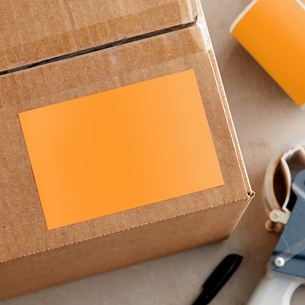 A cardboard box with a yellow rectangular label on it.