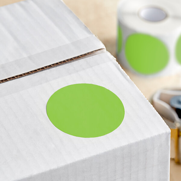 A white box with green circle stickers on it.