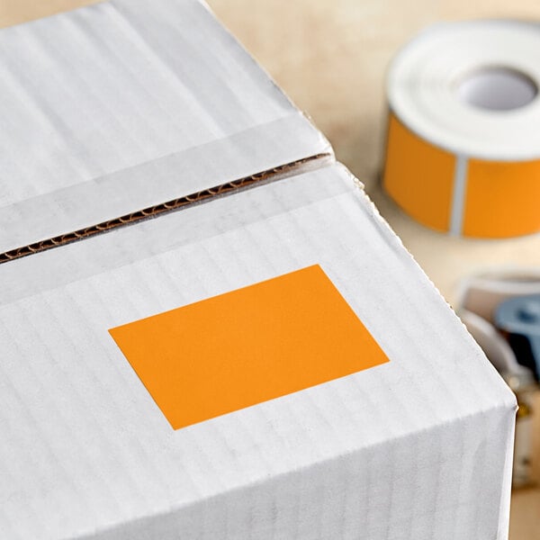 A white box with a roll of Lavex fluorescent orange rectangular inventory labels.