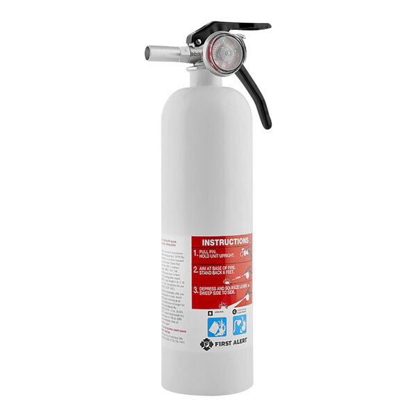 A white First Alert fire extinguisher with red and white text.