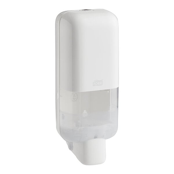A white Tork manual hand sanitizer dispenser.
