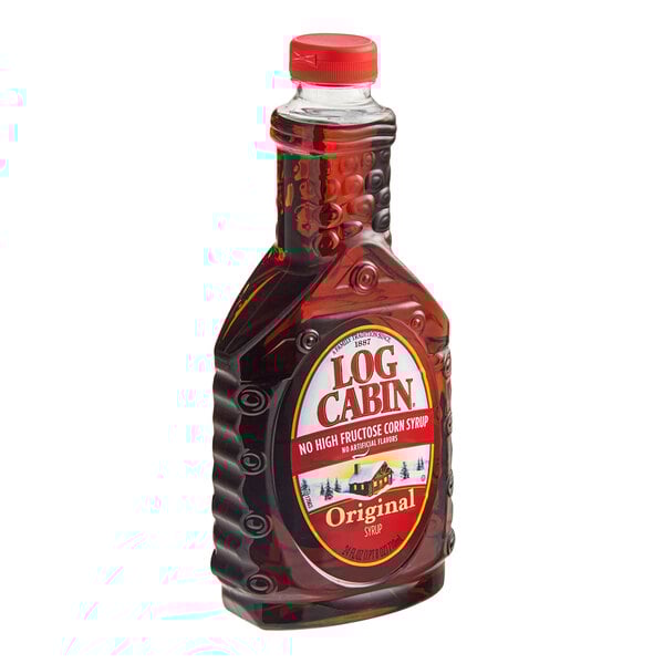 A bottle of Log Cabin Original syrup with a red cap and label.