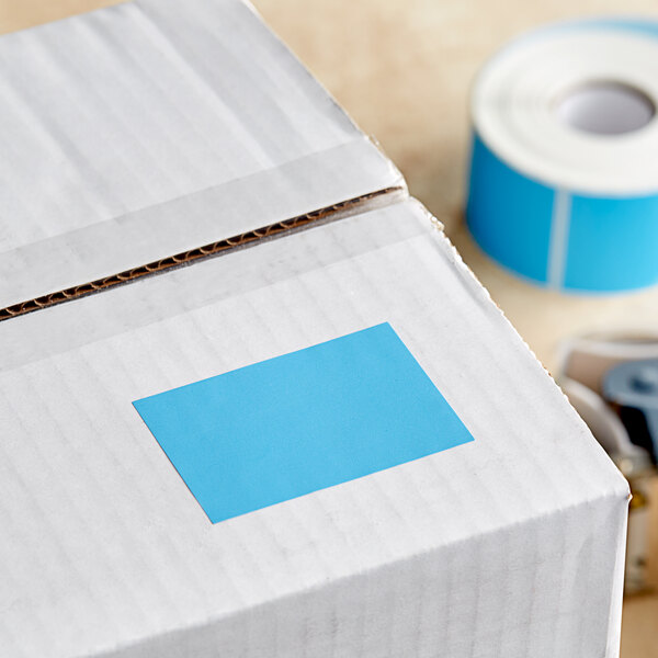 A white box with a roll of sky blue rectangular labels inside.