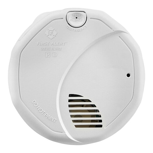 A white First Alarm smoke detector with a round lid.