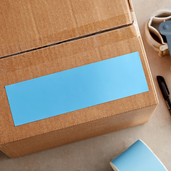 A cardboard box with a blue rectangular label.