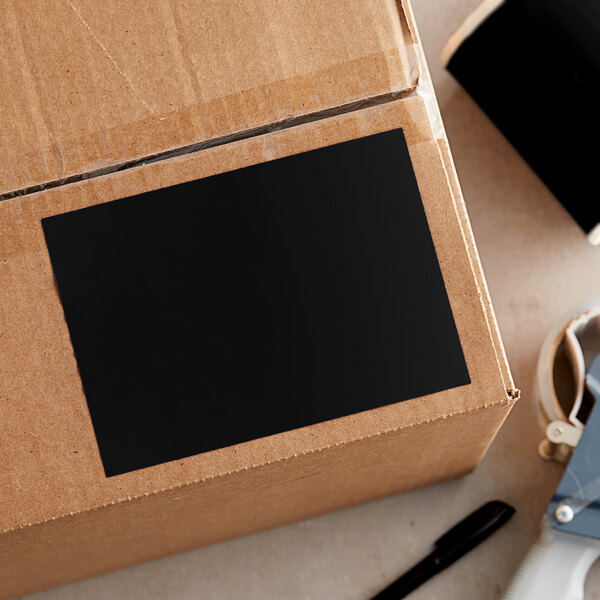 A cardboard box with a black rectangular Lavex inventory label on it.