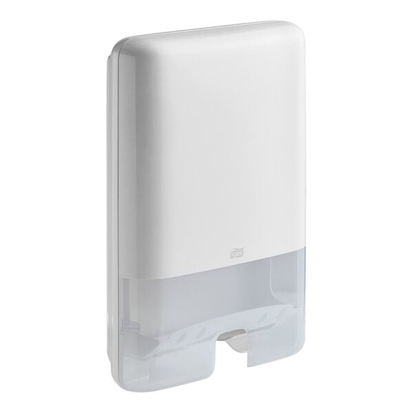 A white rectangular Tork Xpress wall-mount multifold hand towel dispenser with a clear plastic cover.