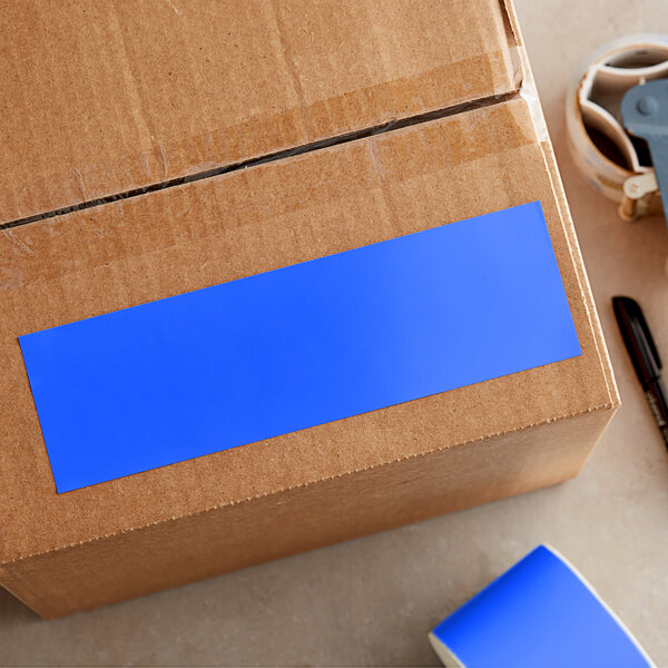 A cardboard box with a roll of Lavex light blue rectangular inventory labels with a blue semi-gloss paper label on the corner.